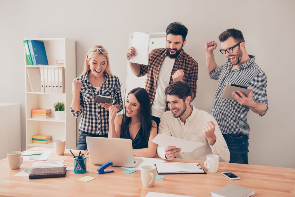 Five people looking at the laptop with their cheering face