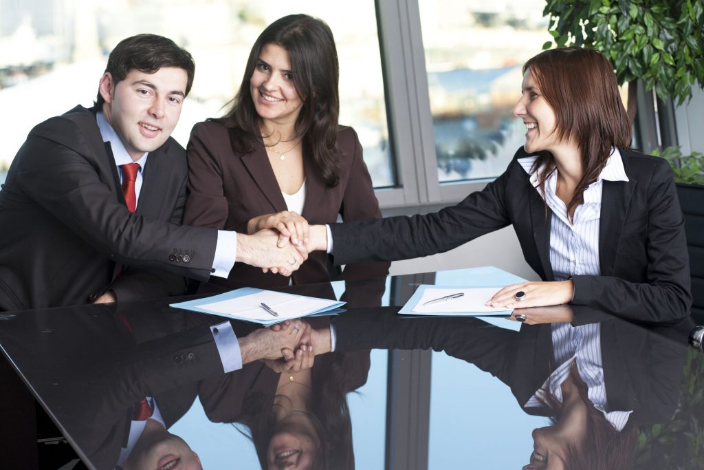 Three people doing a hand shake