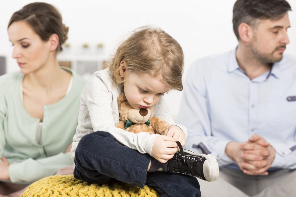 A kid tying her shoe ties